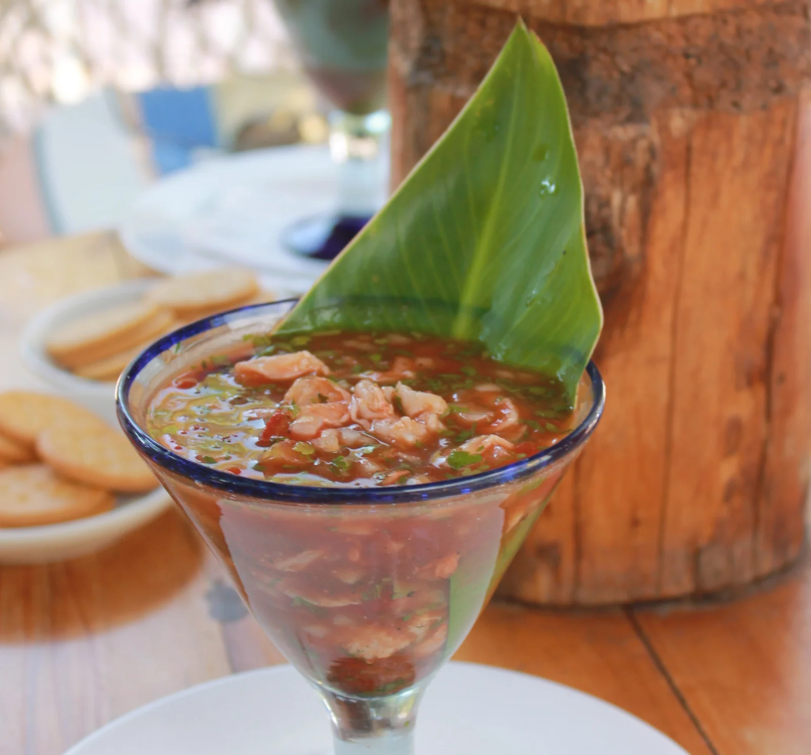 Guatemalan fish ceviche in a glass with a banana leaf, served with saltine crackers