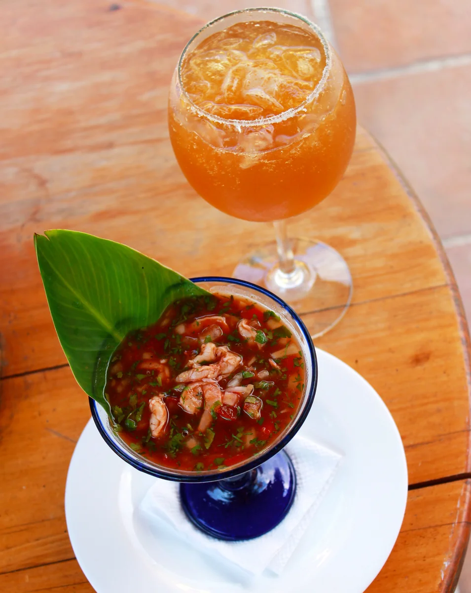 Guatemalan fish ceviche in tomato sauce, served with michelada beer drink