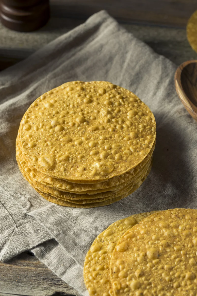 Stack of crispy fried corn tortillas used as the base for Guatemalan tostadas