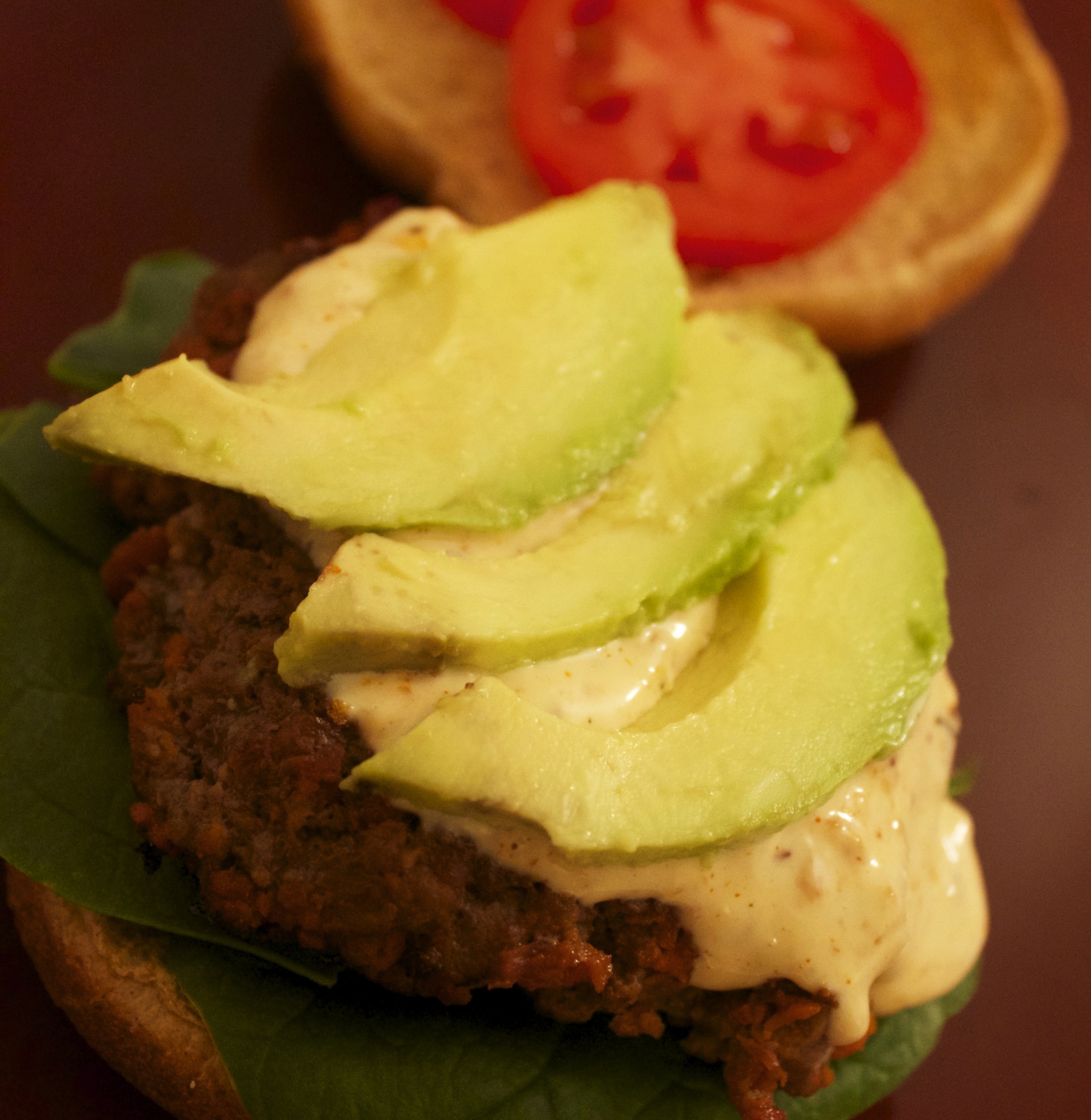 Thin avocado slices top this delicious chorizo burger with blue cheese chipotle sauce