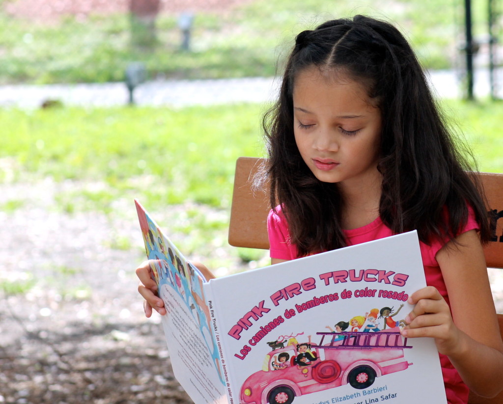 My daughter just loved Pink Fire Trucks and I am happy that she was reading a book that is teaching her so much. Photo: Paula Bendfeldt-Diaz. All Rights Reserved.