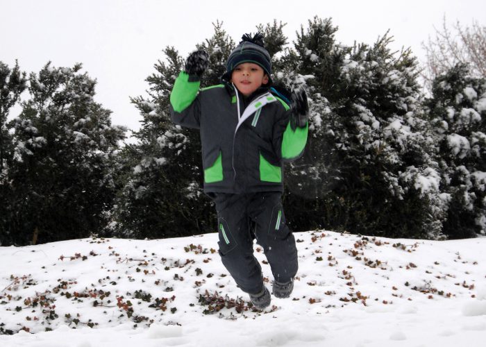 boy jumping in snow