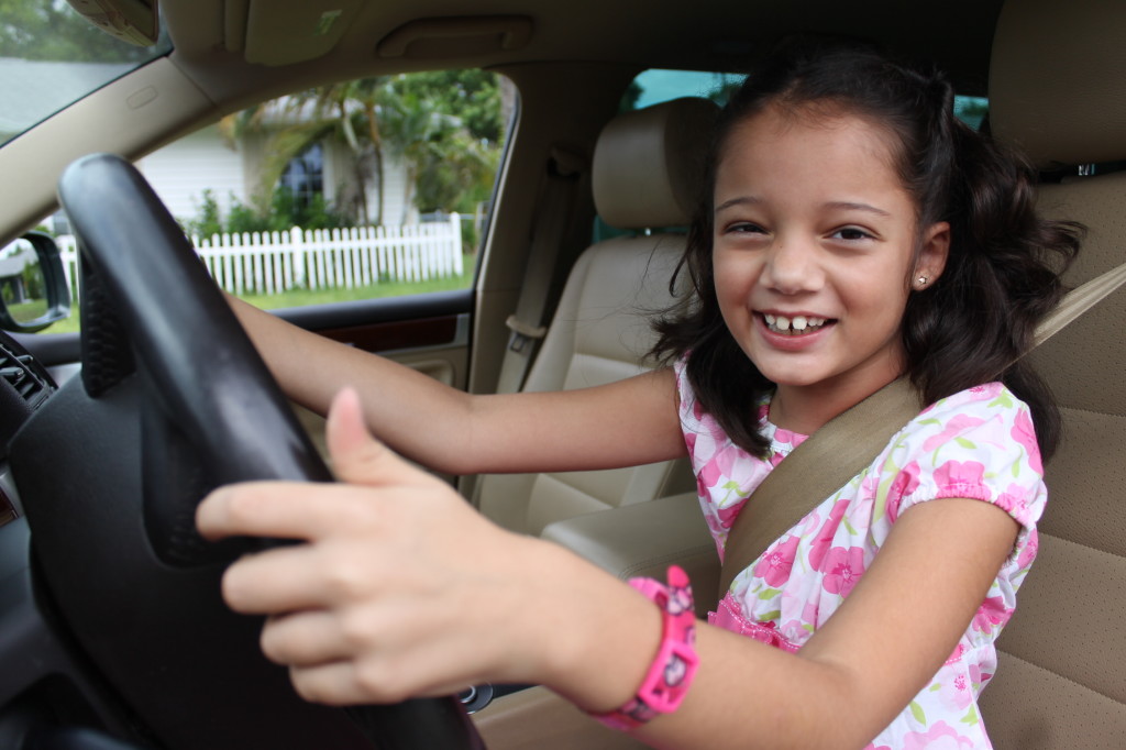 girl pretending to drive car