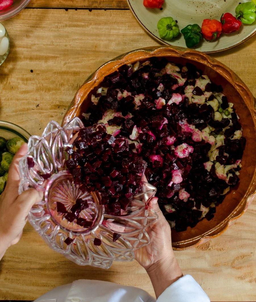 Adding diced beets to the marinated fiambre vegetables last