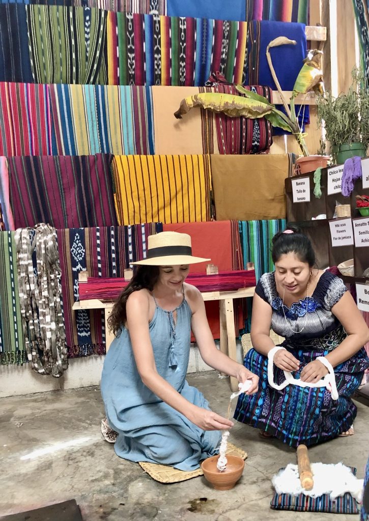 Traveler learning traditional Mayan weaving and textile making in Lake Atitlán Guatemala