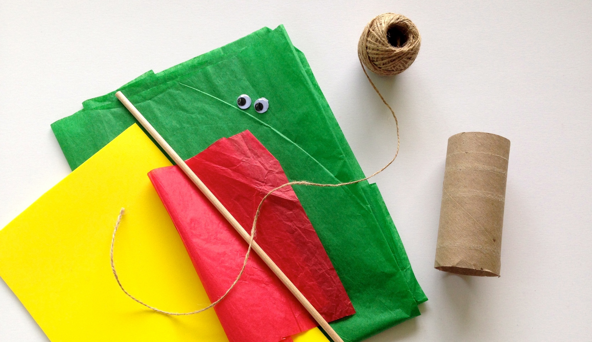 Materials to make Guatemalan quetzal craft with toilet paper tube. 