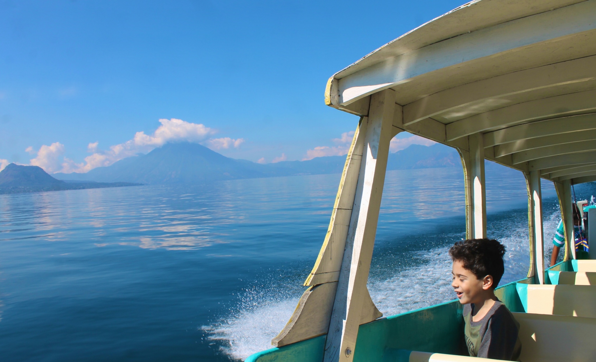 enjoying the view of the volcanos from water taxi in lake Atitlan