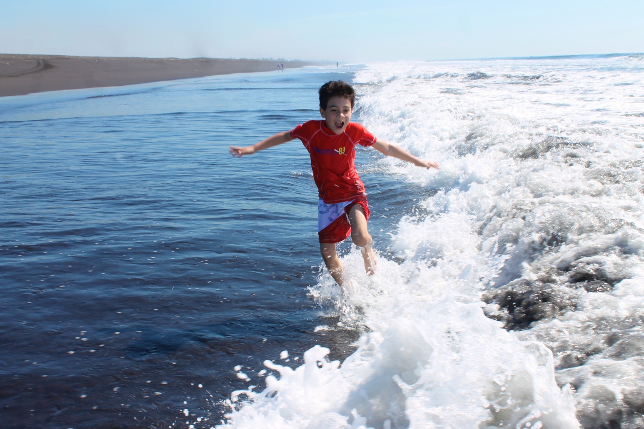 boy jumping waves