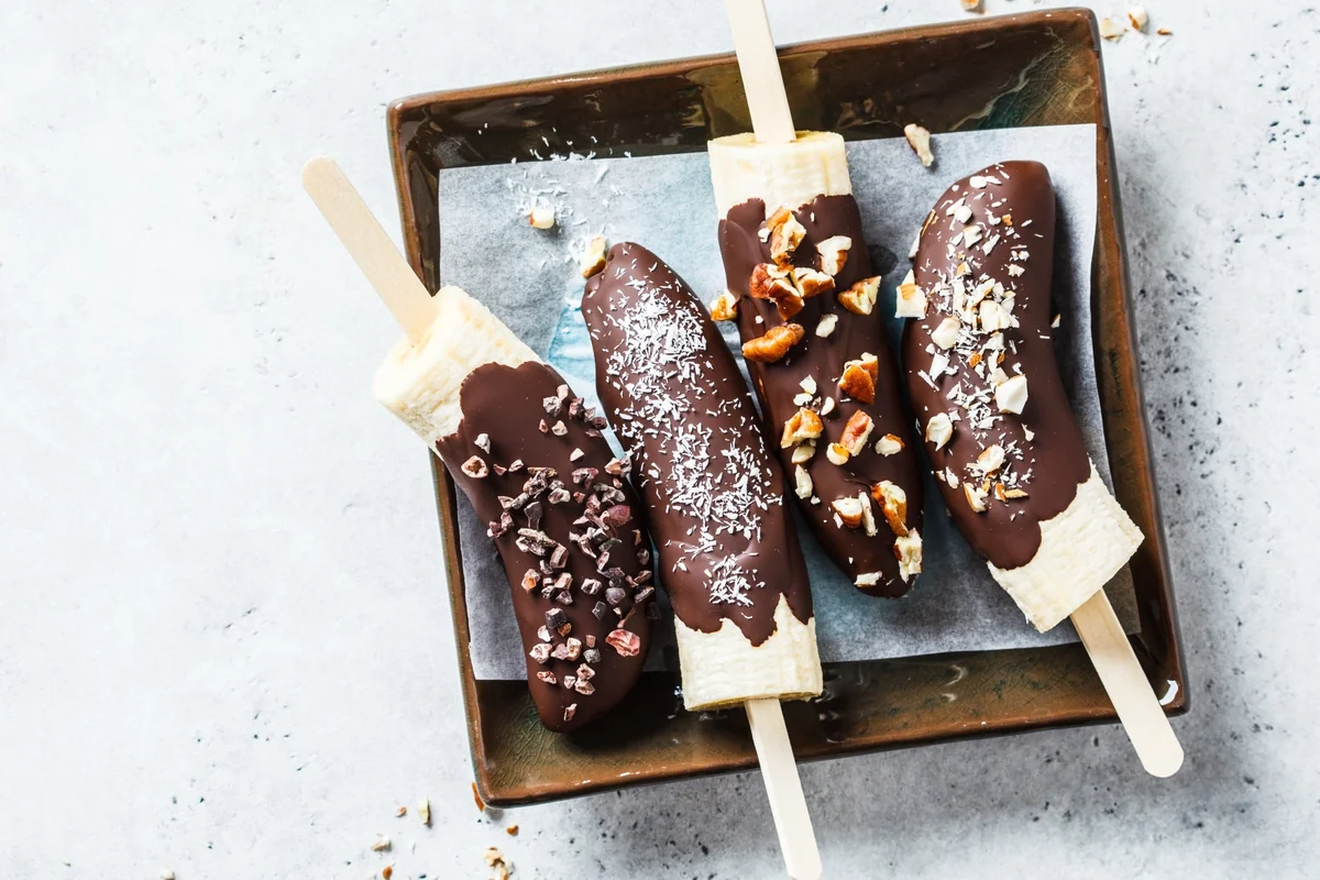 Guatemalan chocobananos, frozen chocolate-dipped bananas on sticks topped with nuts and coconut.