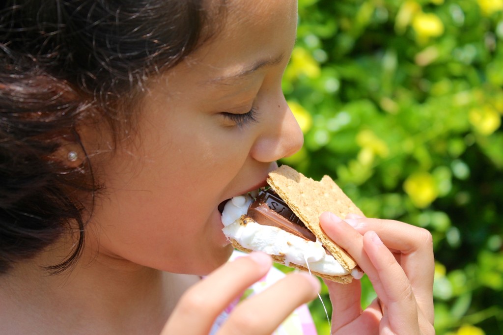 girl eating s'mores