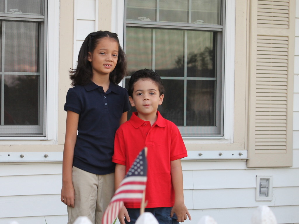 back to school, boy and girl in uniform with american flag