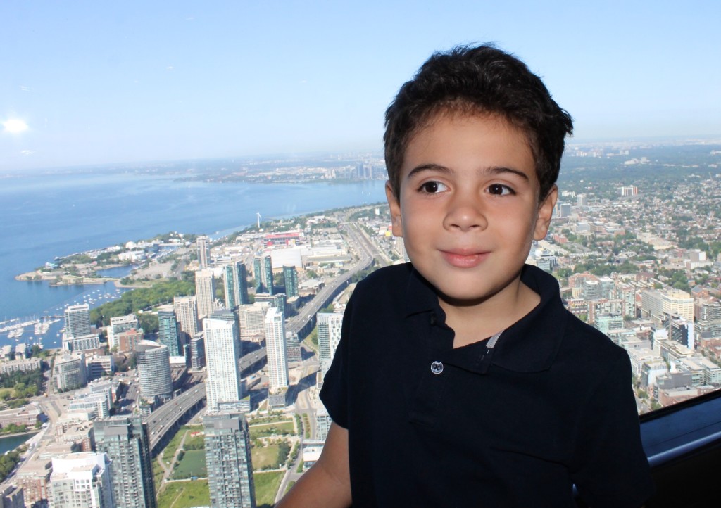 boy and view of Toronto from the CN tower