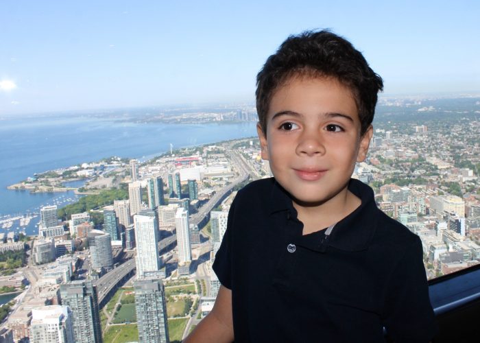 boy and view of Toronto from the CN tower