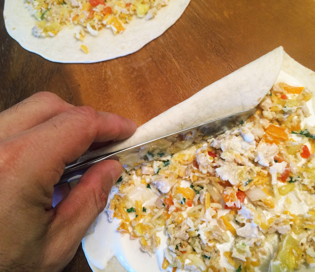 Use a knife to help you roll the tortilla