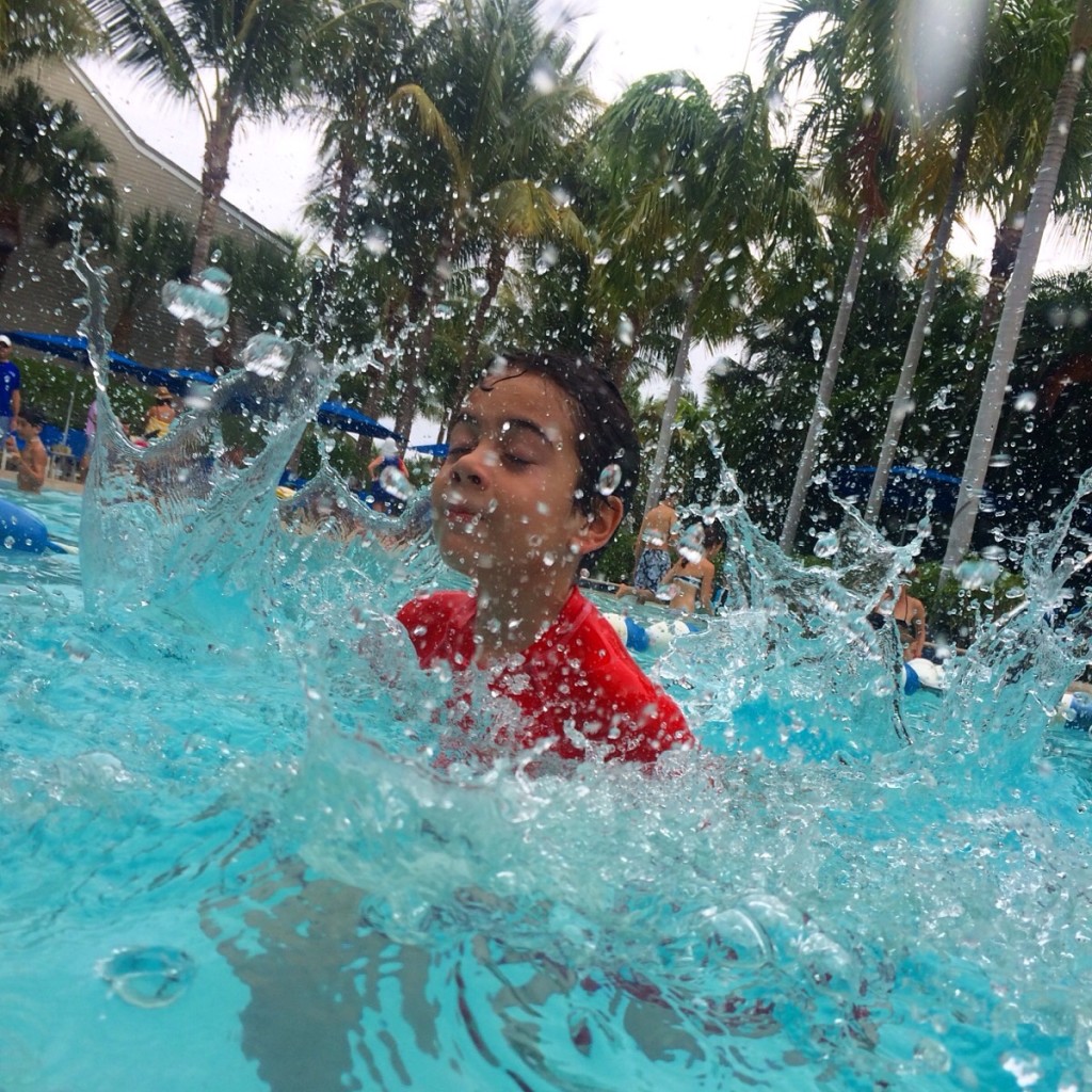 boy splashing in pool in South Seas Island Resort