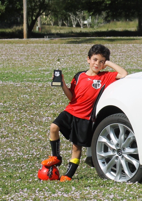 boy with soccer trophy