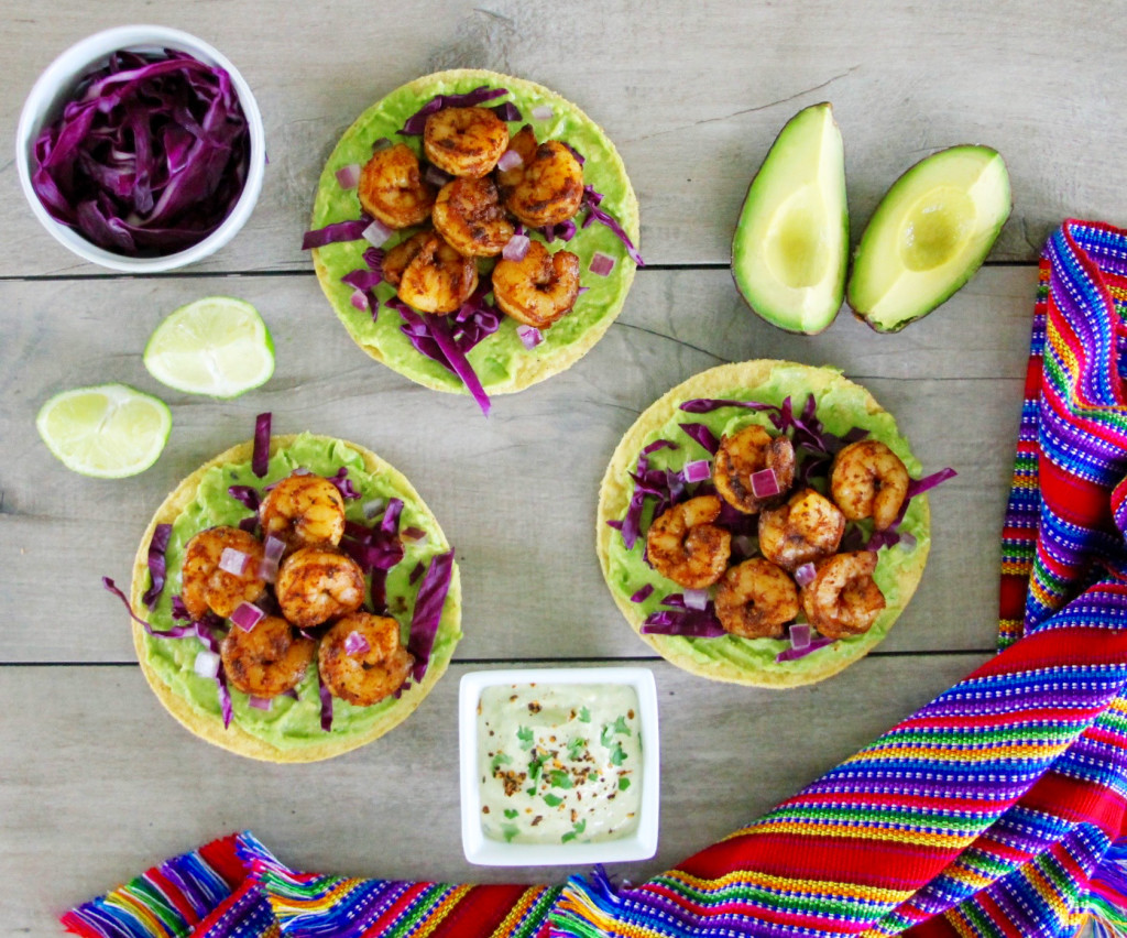 Avocado and chipotle shrimp tostadas topped with cilantro lime crema