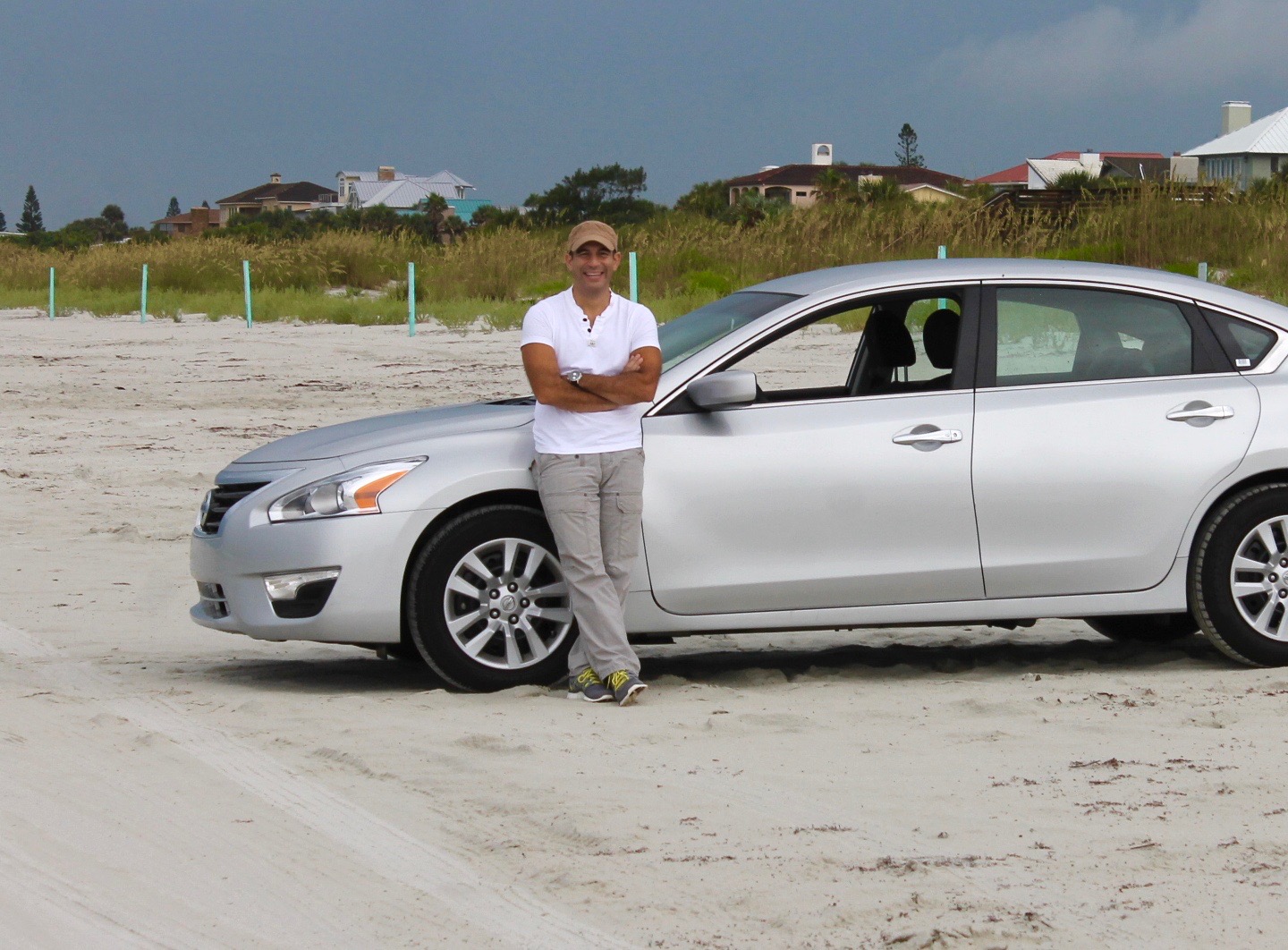 Latino man with car at the beach
