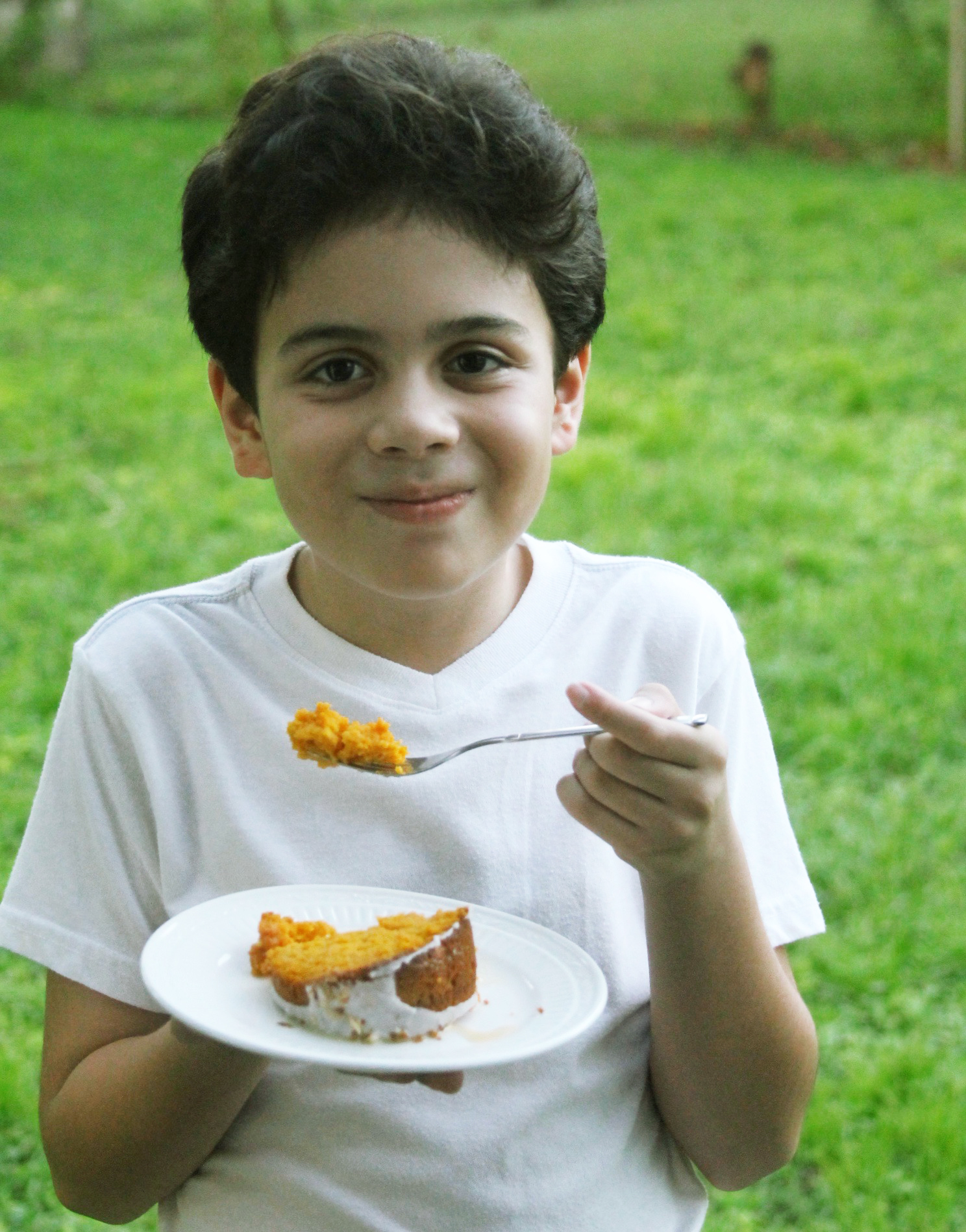  boy eating Pumpkin tres leches cake with coconut glaze