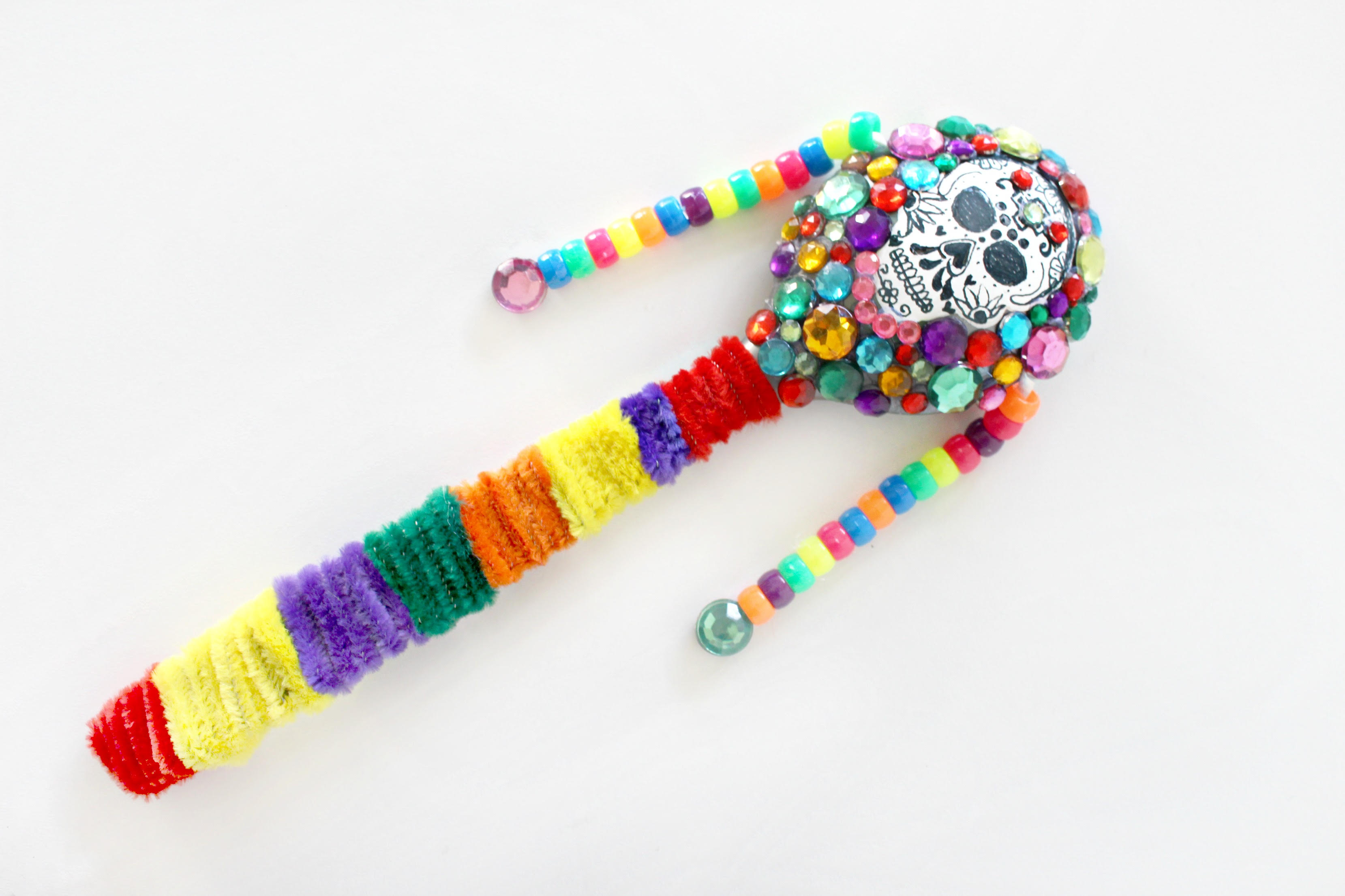 This DIY sugar skull noise maker is a great pipe cleaner Day of the Dead craft for kids. 