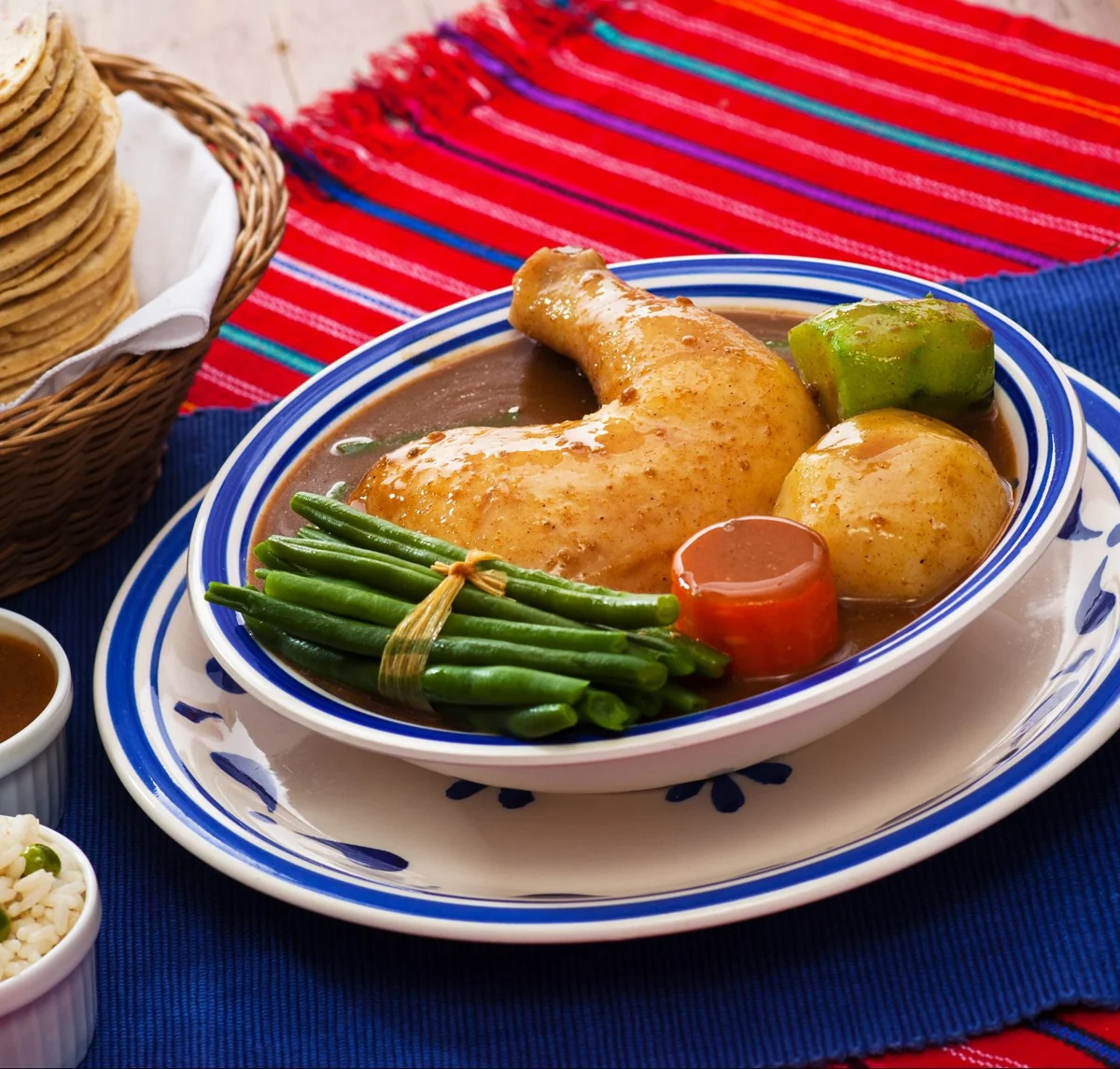 Plato de pepián guatemalteco con pollo, ejote, zanahoria y güisquil