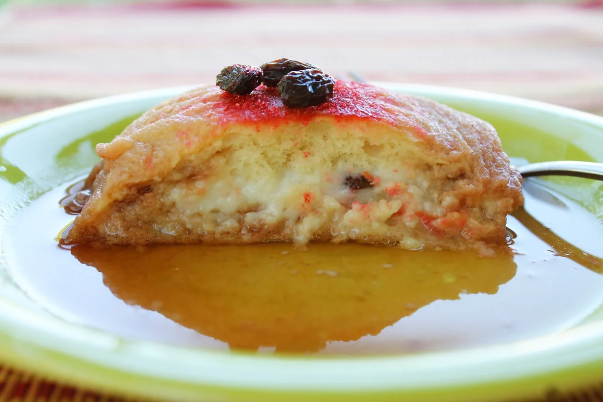 Guatemalan molletes topped with a prune, showing the custard filling