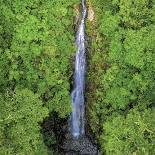Tall jungle waterfall at Cascadas de Metzabal near Lake Atitlán Guatemala