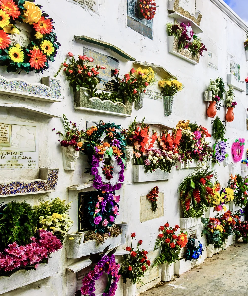 Families visiting decorated graves on Día de Todos los Santos in Guatemala
