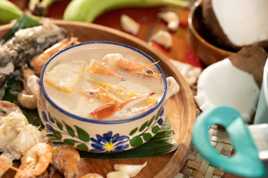 A bowl of tapado with shrimp, crab and plantain in coconut broth