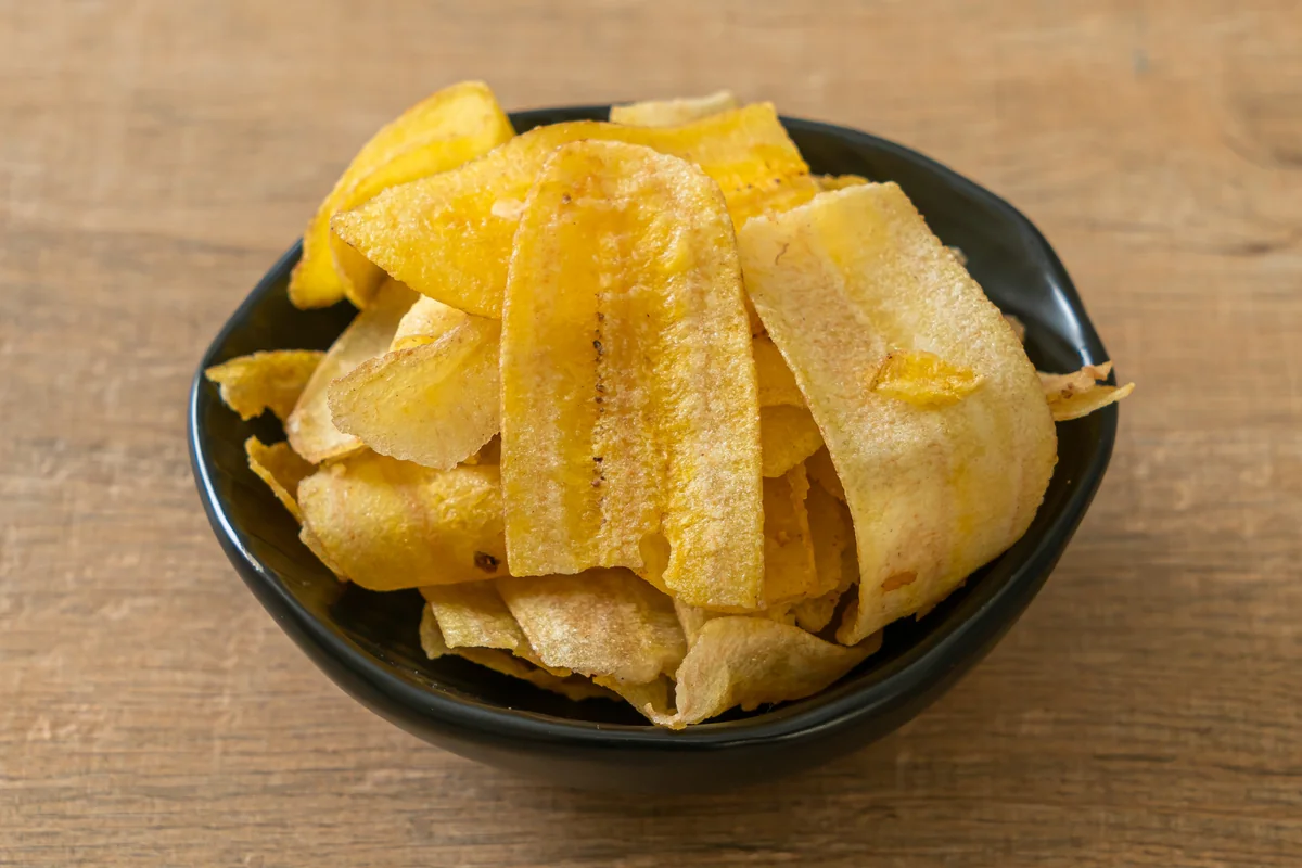 Plataninas, thin crisp Guatemalan plantain chips served in a dark bowl