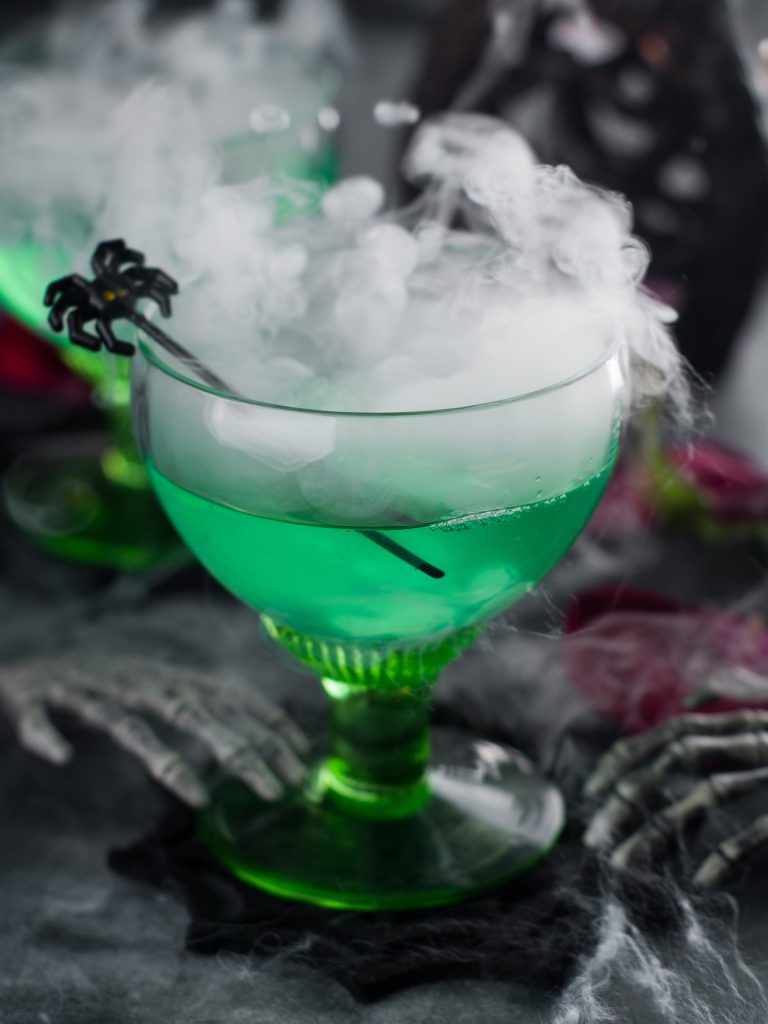 Spooky green Halloween cocktail with spider