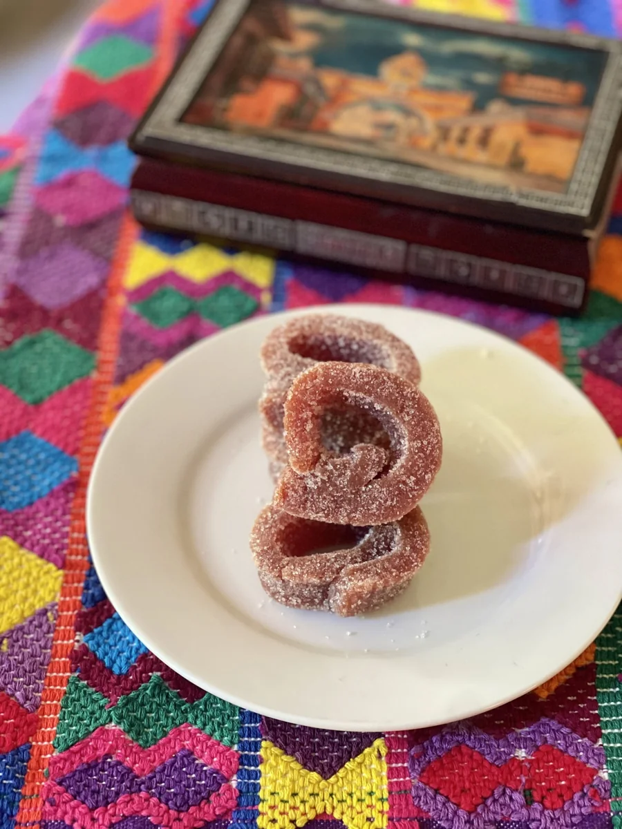 Sugar-dusted colochos de guayaba guava paste rolls on a white plate