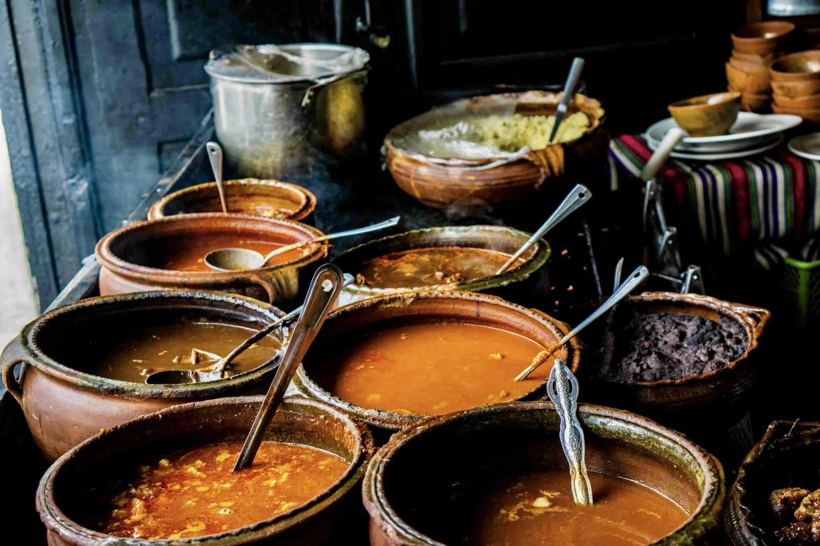 Pots of traditional Guatemalan stews at a La Cuevita de los Urquizú food stall in Antigua