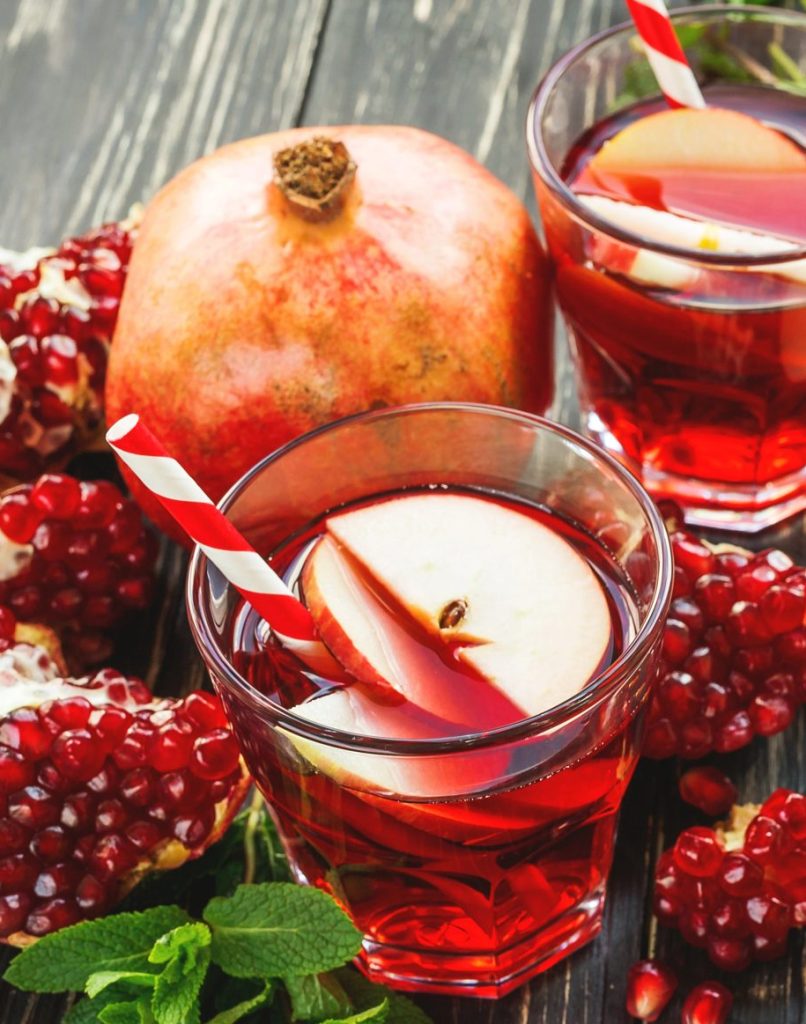 Pomegranate apple sangria cocktail with red wine and apple slices, a festive winter sangria and Christmas cocktail for holiday gatherings