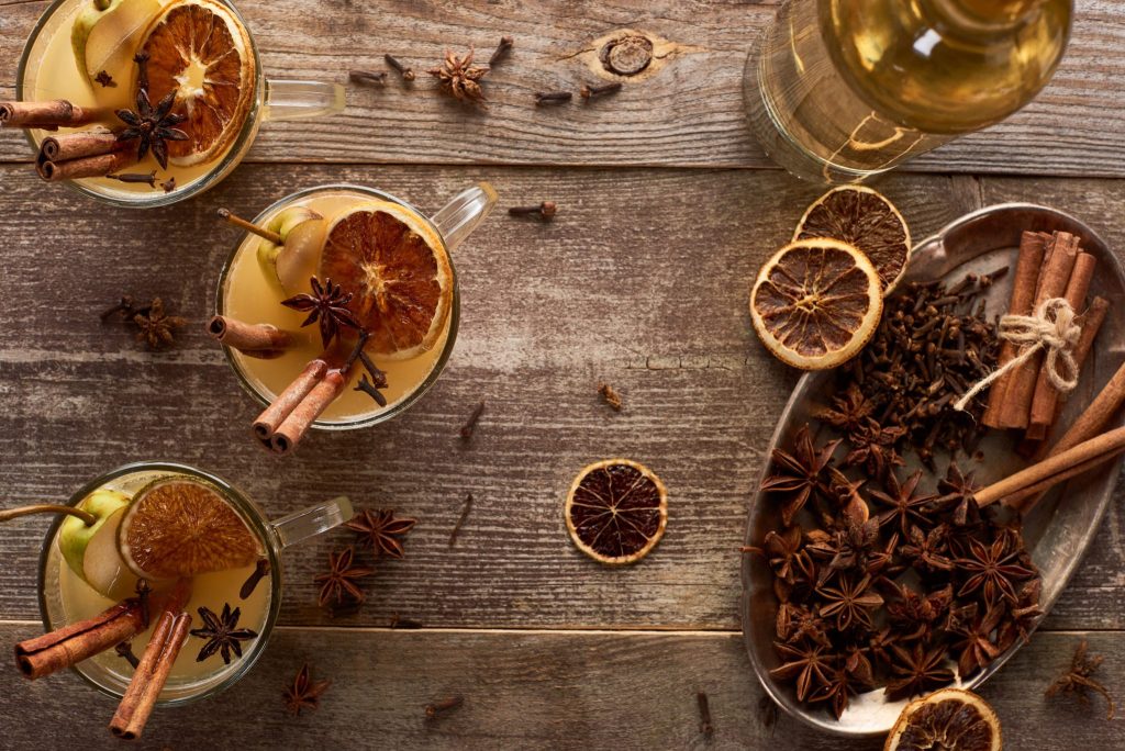 Pear mulled white wine with cinnamon sticks, star anise, and dried citrus slices
