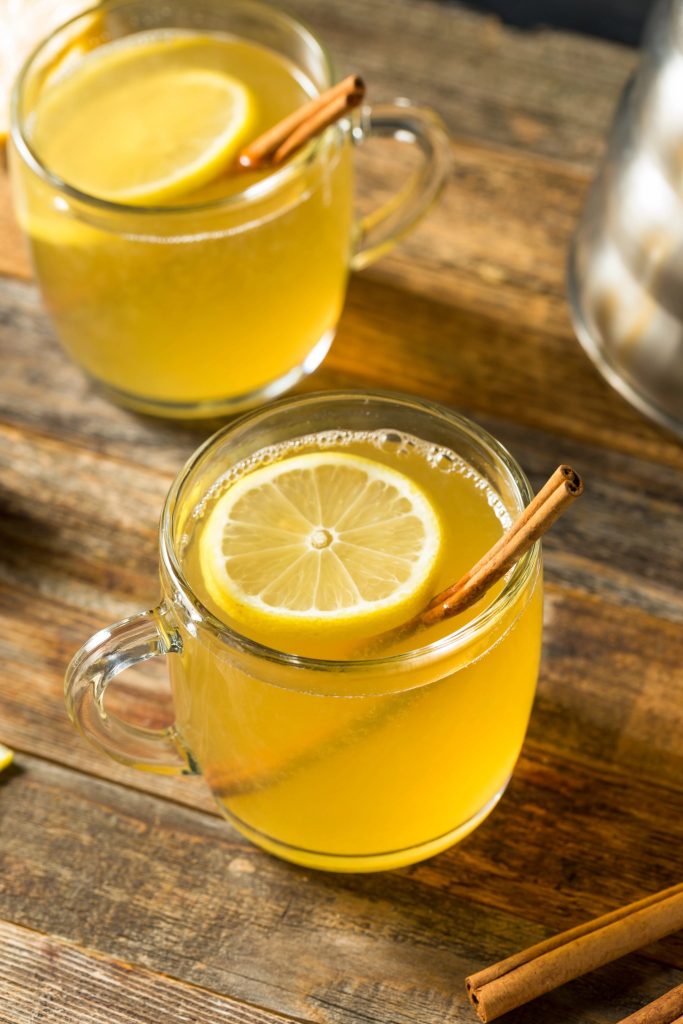 A warm lemon hot toddy with cinnamon and honey, a classic winter whiskey cocktail recipe.