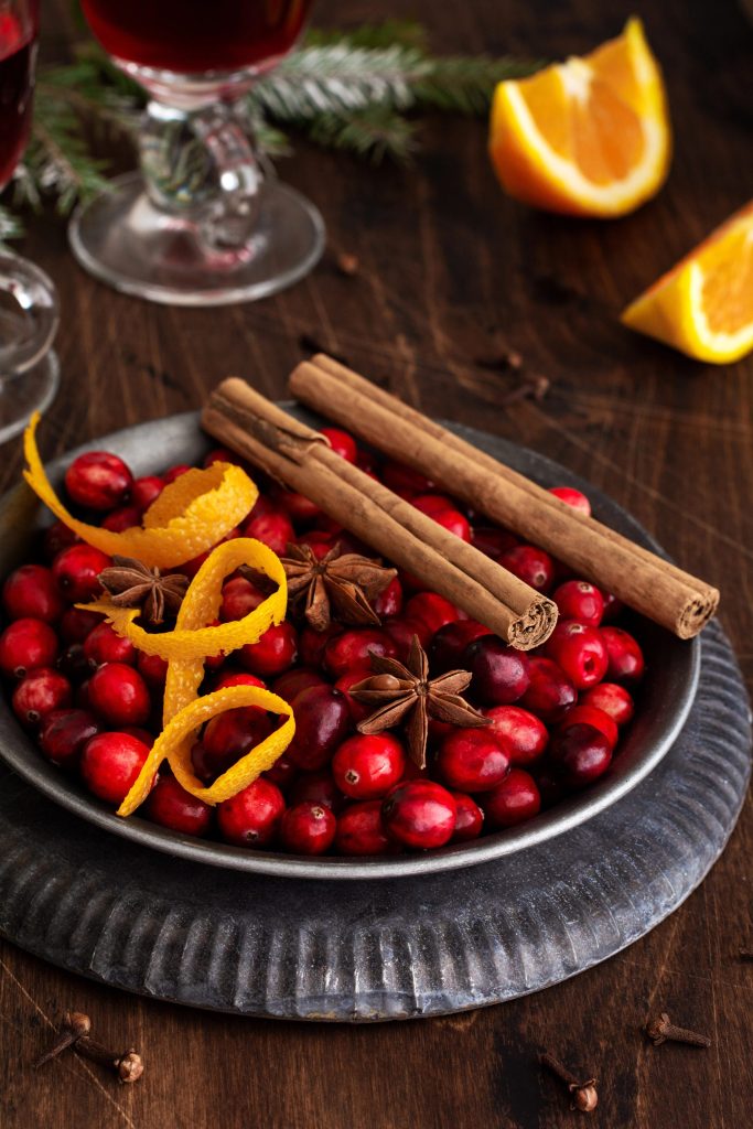 Fresh cranberries with cinnamon sticks and orange peel for holiday sangria