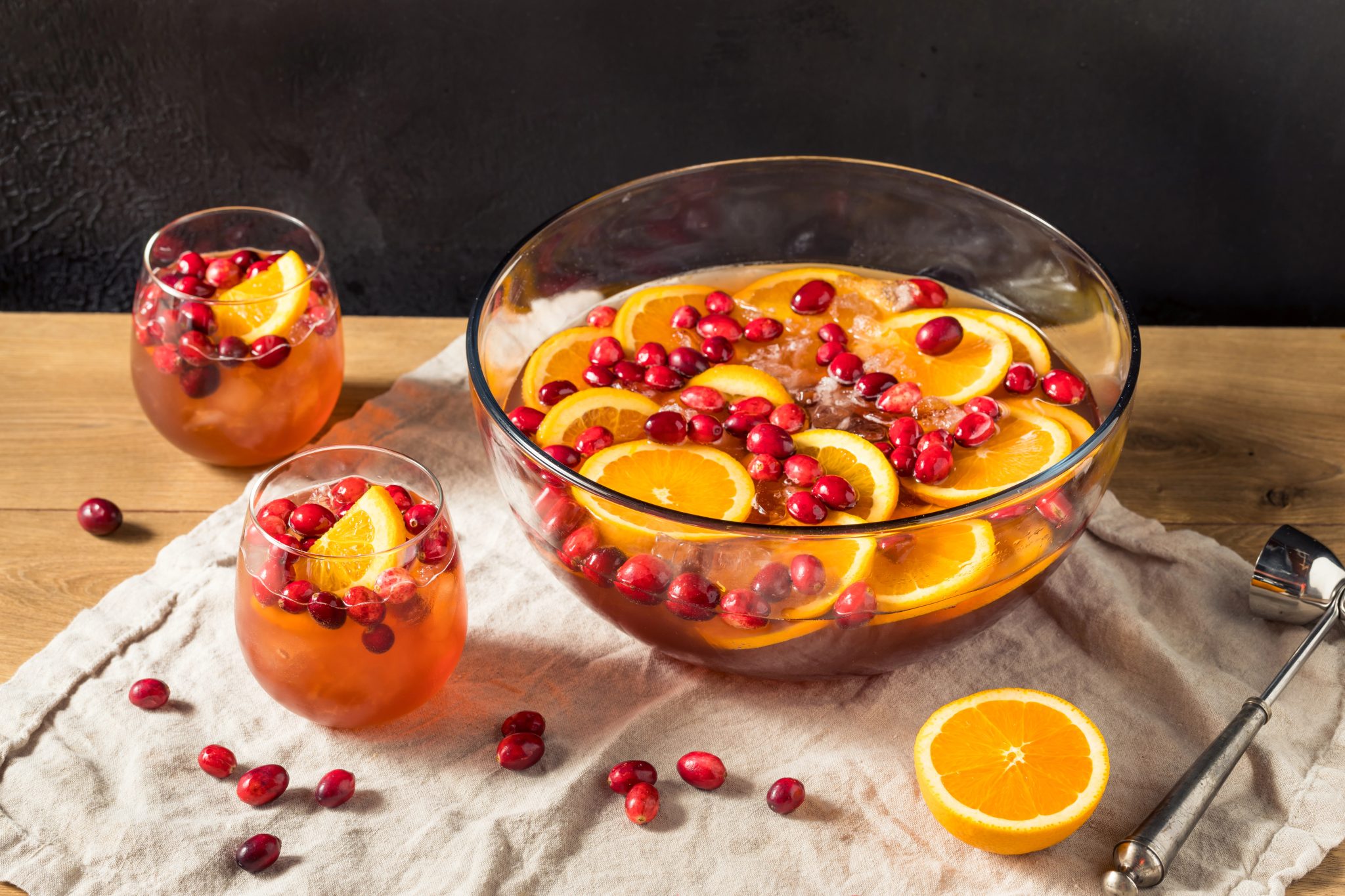 Cranberry champagne punch in a glass bowl with oranges and cranberries for a holiday party