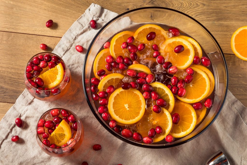 Overhead view of cranberry champagne punch with orange slices and fresh cranberries