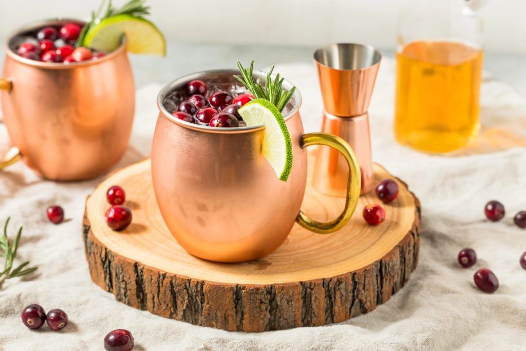 This cranberry Moscow mule recipe is a festive winter cocktail made with vodka, ginger beer, fresh cranberries, and lime. A refreshing holiday mule perfect for Christmas parties and winter entertaining.
