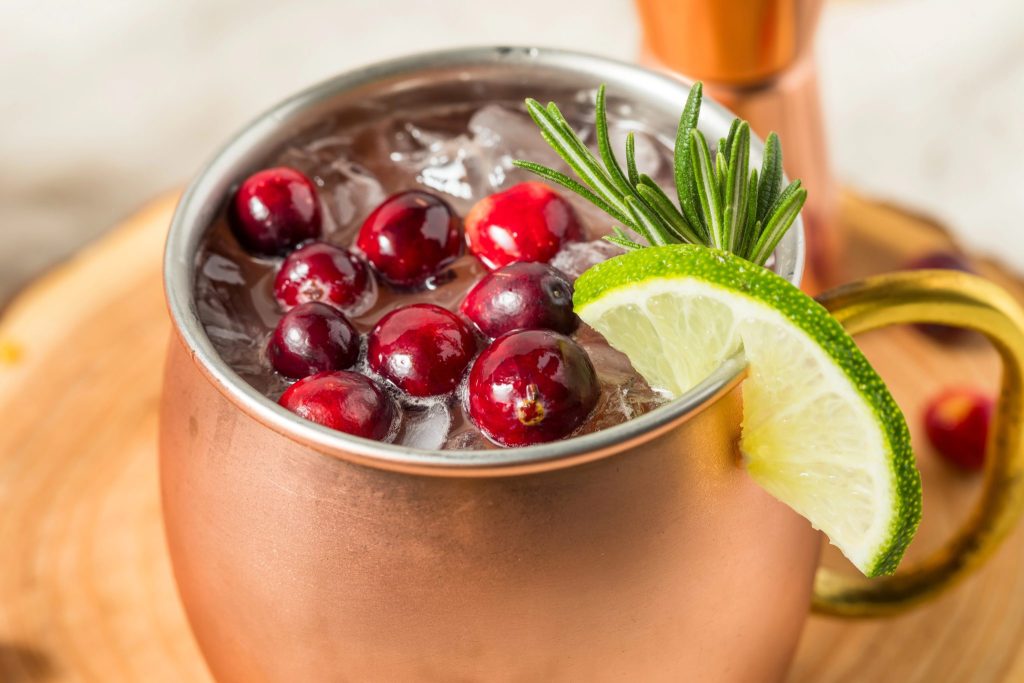 Cranberry Moscow mule Christmas cocktail made with vodka, ginger beer, lime juice, and fresh cranberries. A crowd-pleasing winter cocktail that’s festive without being heavy.