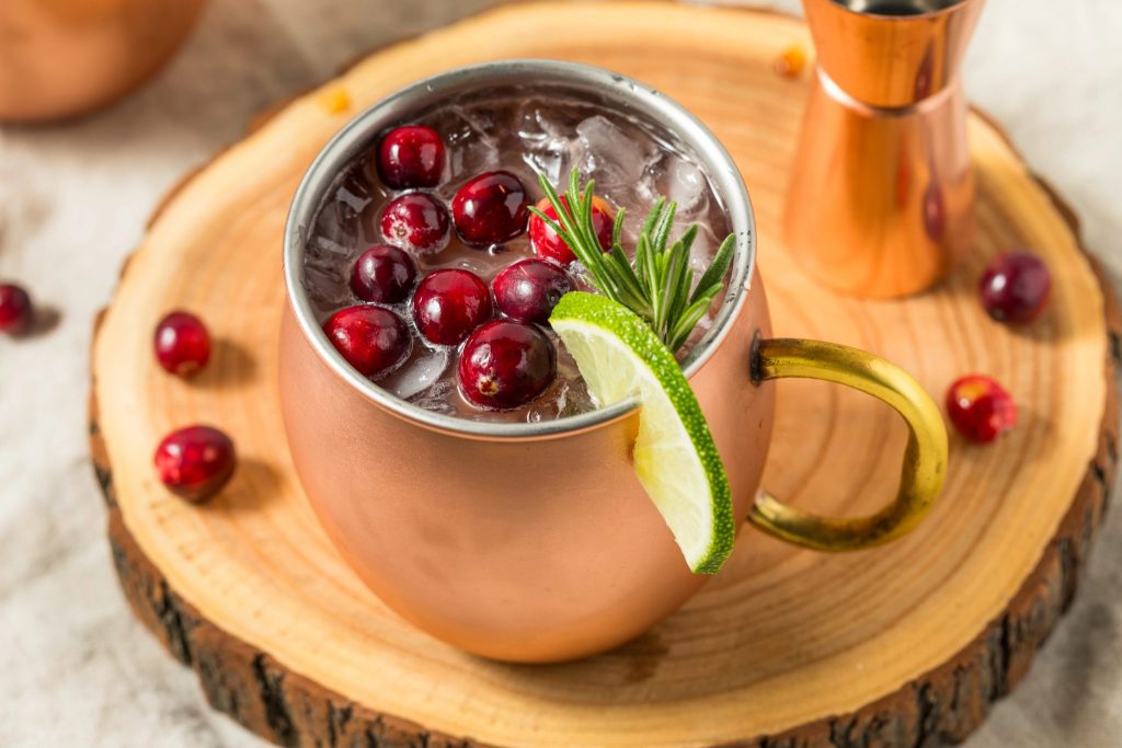 Holiday cranberry Moscow mule recipe served in a copper mug with fresh cranberries and lime. A simple Christmas cocktail that’s crisp, refreshing, and perfect for winter entertaining.