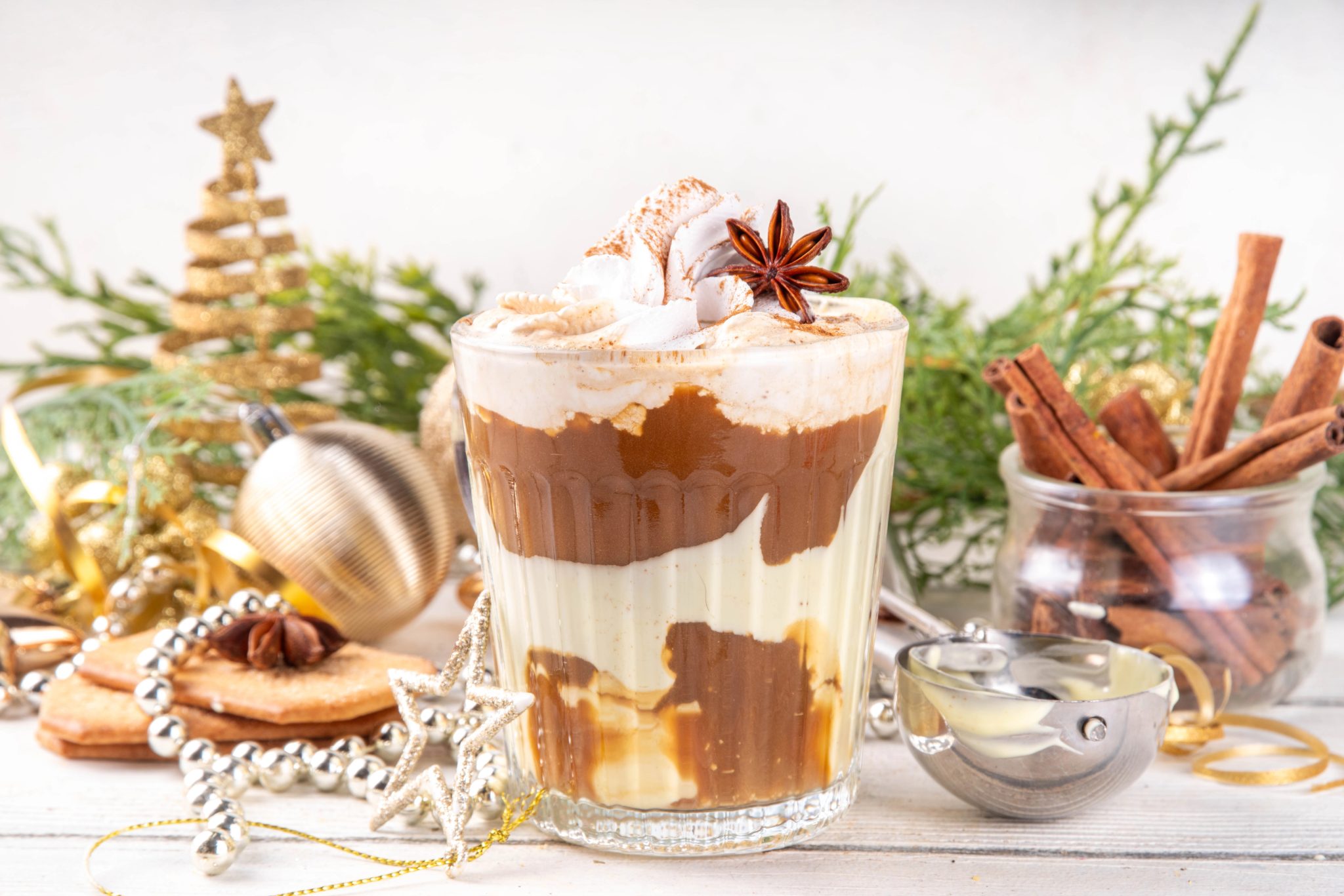 Looking for a boozy coffee recipe for the holidays? This Bourbon eggnog affogato cocktail with espresso and eggnog ice cream layered in a glass mug, topped with whipped cream and star anise, is the perfect Christmas dessert drink!