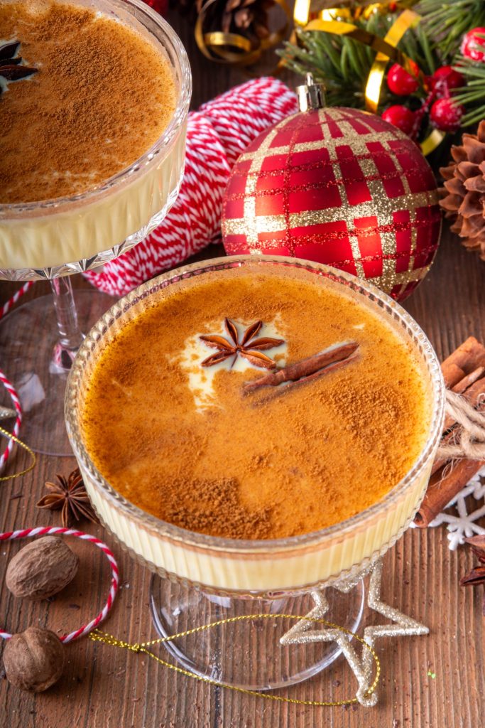 Eggnog martini garnished with cinnamon and star anise in a festive holiday setting