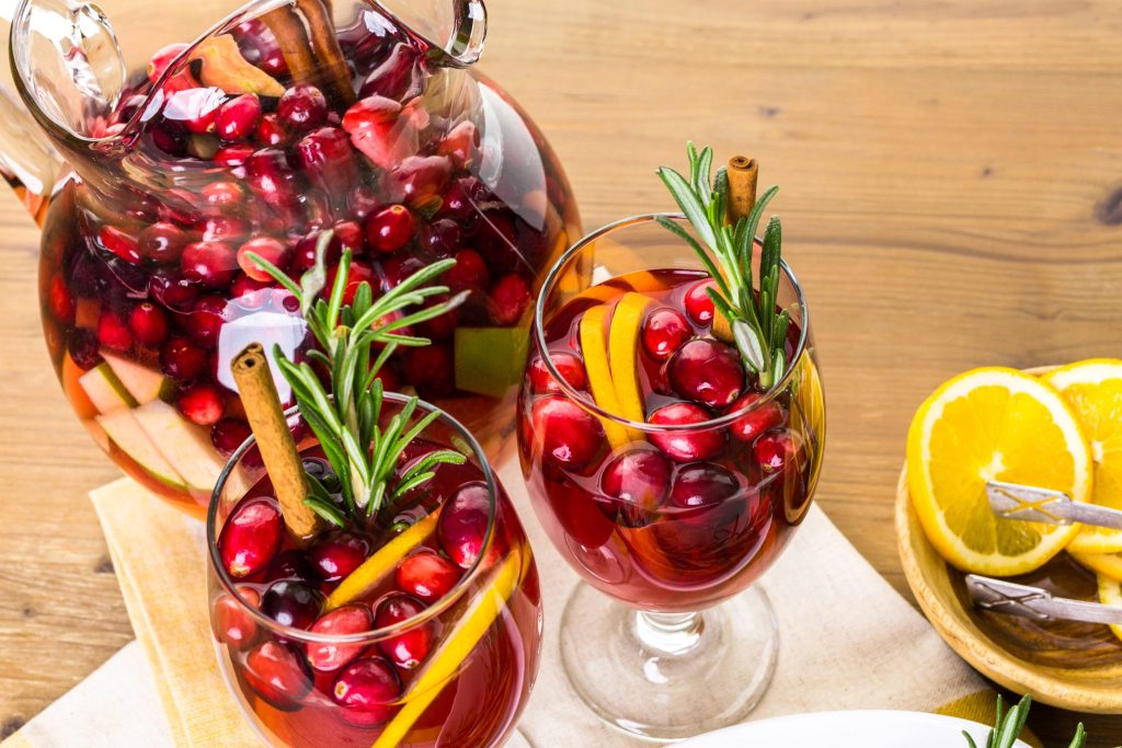 Cranberry sangria served in glasses with orange slices and fresh cranberries
