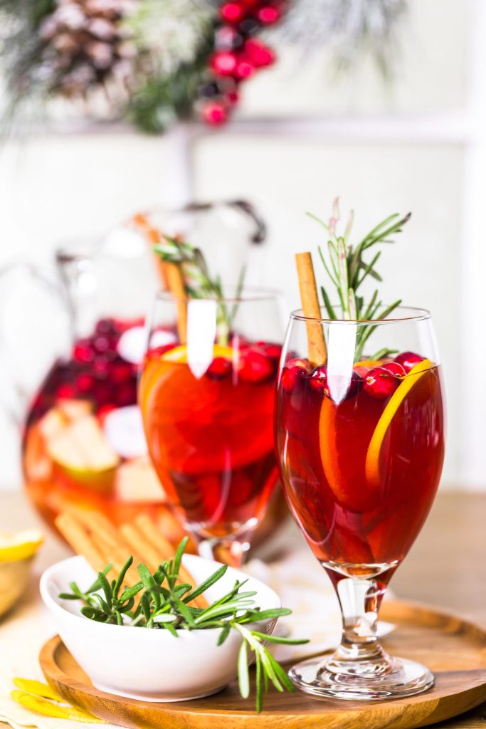 Delicious cranberry sangria served in glasses with orange slices and fresh cranberries