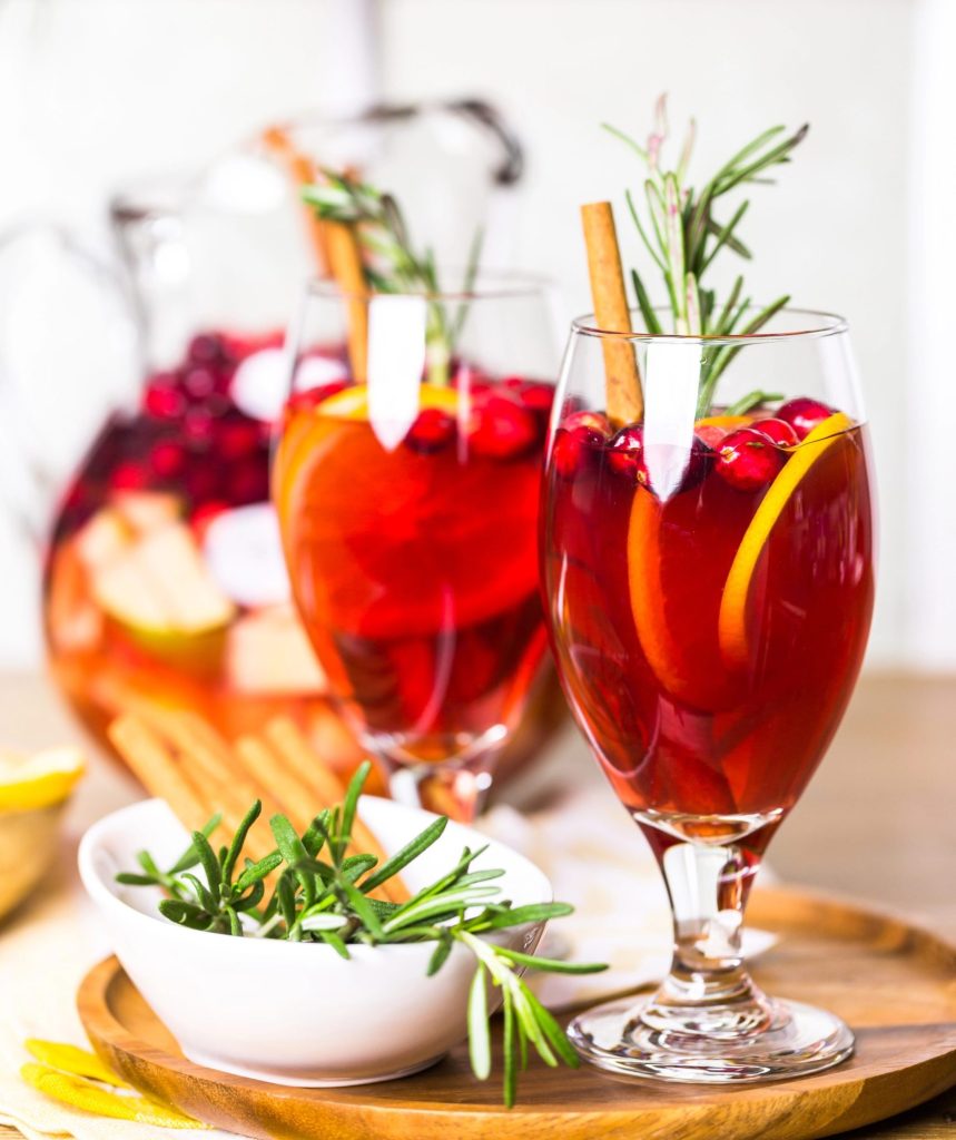 Delicious cranberry sangria served in glasses with orange slices and fresh cranberries