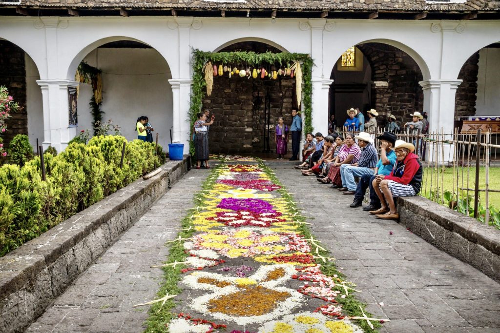 Flower petal alfombra and ceremonial fruit bower in the atrio of the Iglesia Parroquial during Holy Week in Santiago Atitlán — Semana Santa traditions Guatemala