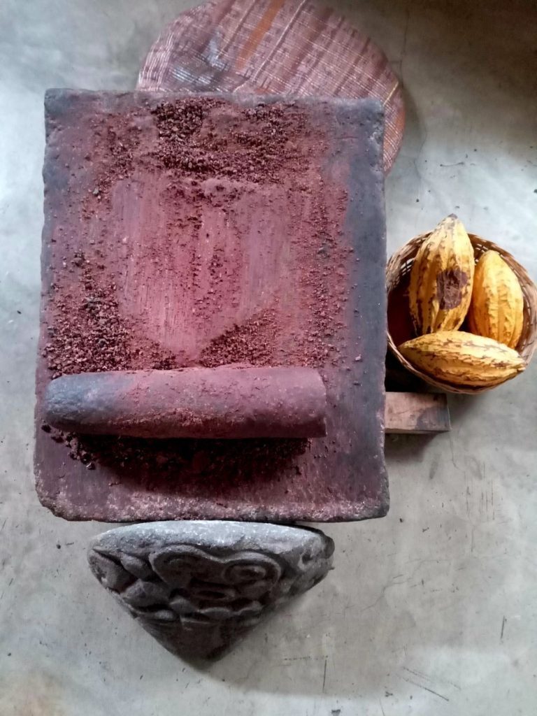 Traditional cacao grinding stone and cacao pods used in Guatemala
