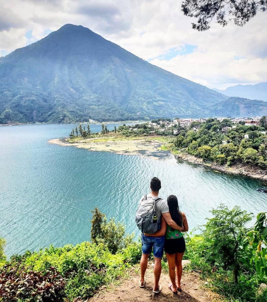 Couple overlooking Lake Atitlán and Santiago Atitlán from a scenic viewpoint